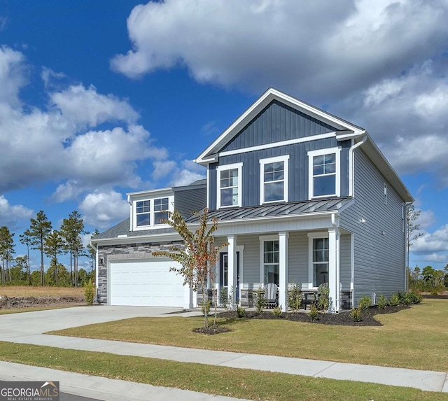 508 Regency Trl, Acworth, GA 30102 - view of front facade with covered porch, concrete driveway, a front yard, and a standing seam roof