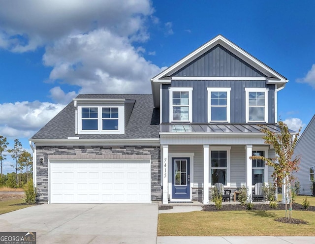 508 Regency Trl, Acworth, GA 30102 - craftsman-style home featuring a porch, stone siding, concrete driveway, a front lawn, and a standing seam roof