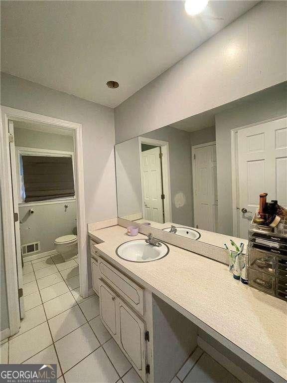1838 Cates Ct, Snellville, GA 30078 - bathroom featuring vanity, toilet, and tile patterned floors