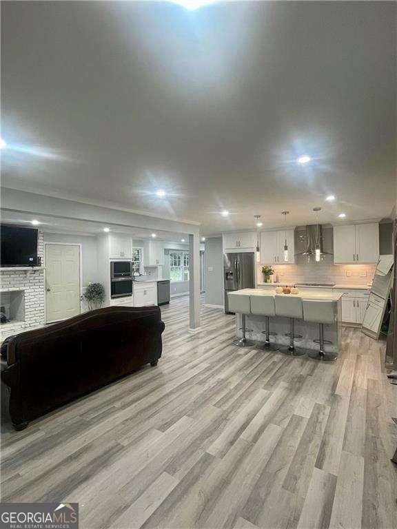1838 Cates Ct, Snellville, GA 30078 - living room with light wood-style floors, recessed lighting, and a fireplace
