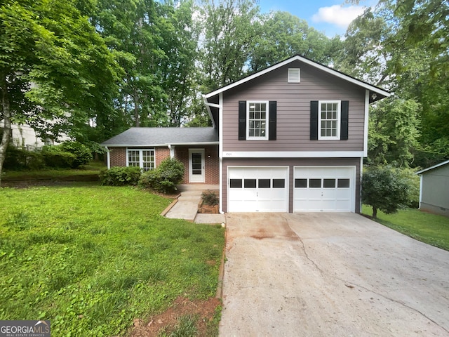 4504 Cedar Ridge Trl, Stone Mountain, GA 30083 - split level home with an attached garage, a front yard, concrete driveway, and brick siding
