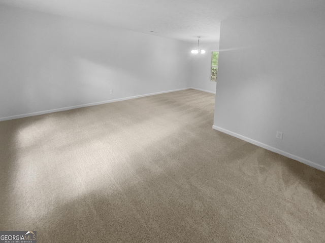 4504 Cedar Ridge Trl, Stone Mountain, GA 30083 - carpeted empty room featuring a chandelier and baseboards