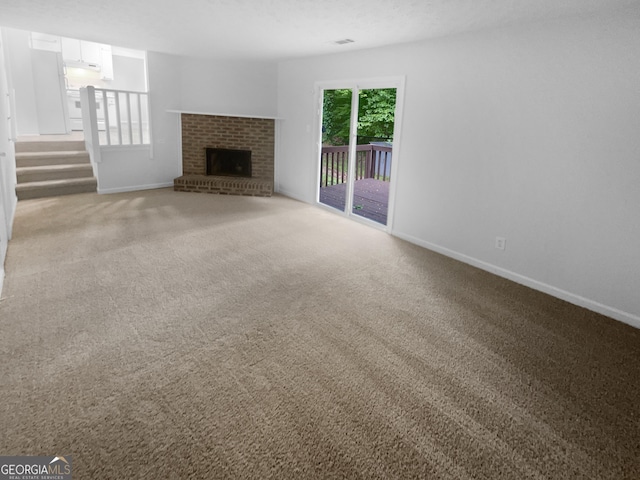 4504 Cedar Ridge Trl, Stone Mountain, GA 30083 - unfurnished living room featuring baseboards, a brick fireplace, and carpet