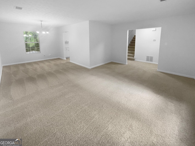 4504 Cedar Ridge Trl, Stone Mountain, GA 30083 - empty room featuring a chandelier, light colored carpet, baseboards, and stairway
