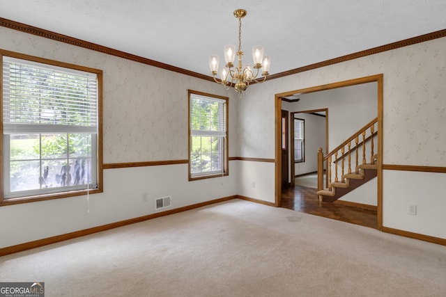 spare room featuring baseboards, carpet floors, a chandelier, stairway, and wallpapered walls