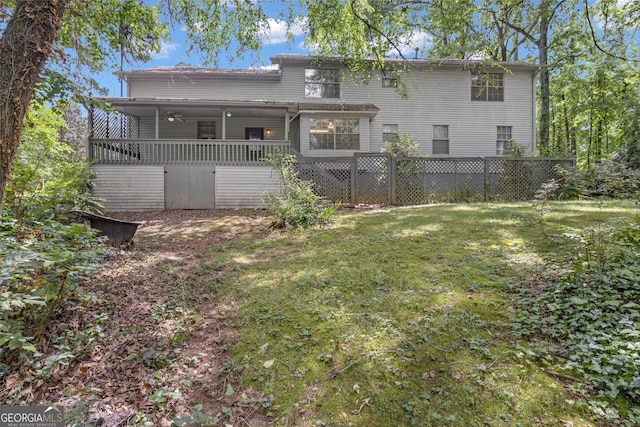 rear view of property featuring a lawn