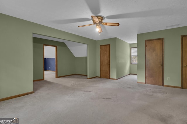 bonus room with a ceiling fan, baseboards, and carpet floors