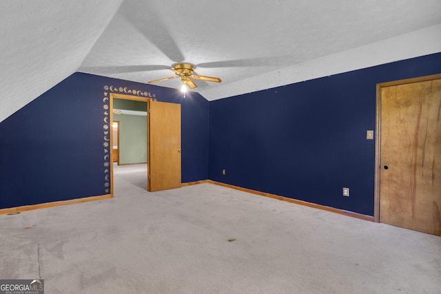 bonus room with vaulted ceiling, ceiling fan, baseboards, carpet floors, and a textured ceiling