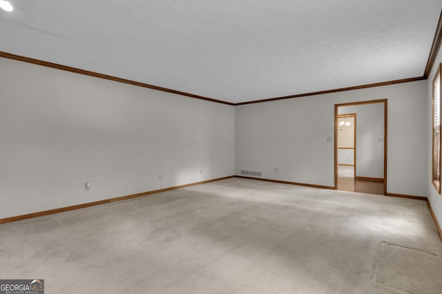 spare room with light colored carpet, baseboards, and ornamental molding