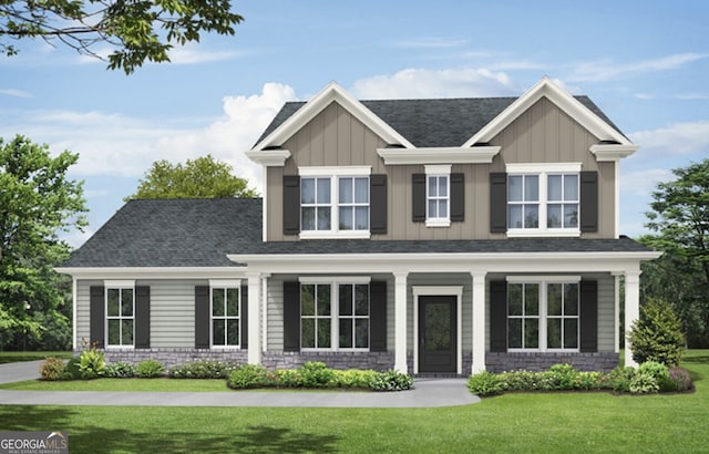 craftsman-style home with a front yard, board and batten siding, and a shingled roof