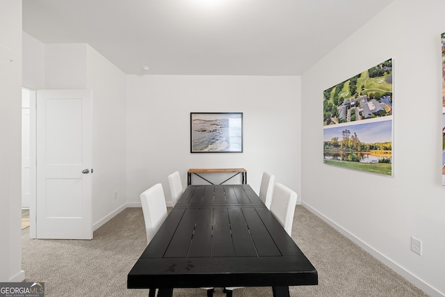 carpeted dining space with baseboards
