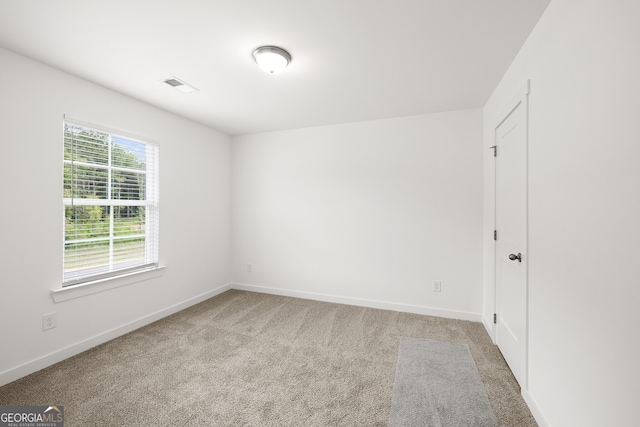spare room with carpet flooring and baseboards