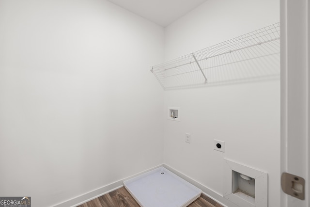 washroom featuring hookup for an electric dryer, hookup for a washing machine, dark wood-type flooring, and baseboards