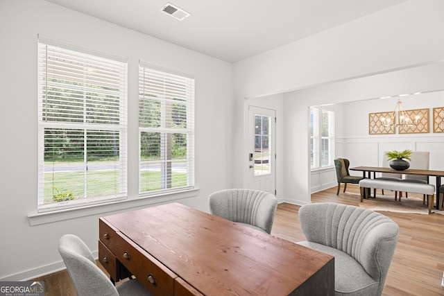 office with plenty of natural light and a chandelier