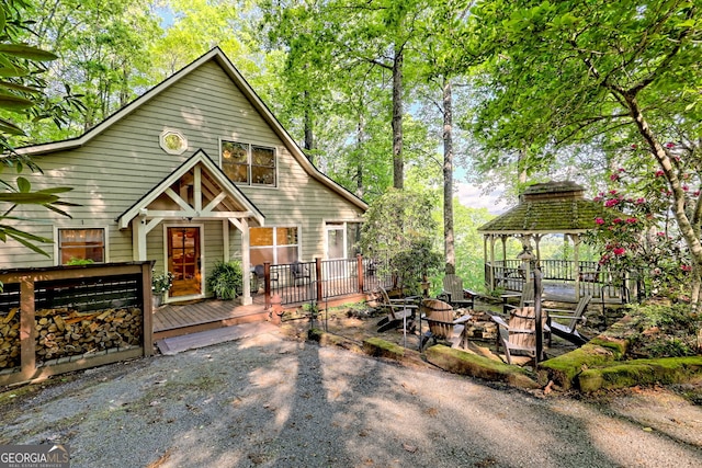 rustic home with a gazebo and a wooden deck