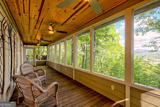 sunroom featuring ceiling fan and plenty of natural light