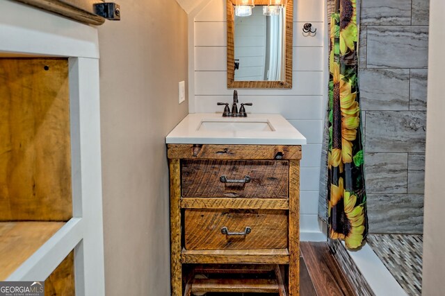 bathroom with curtained shower and vanity