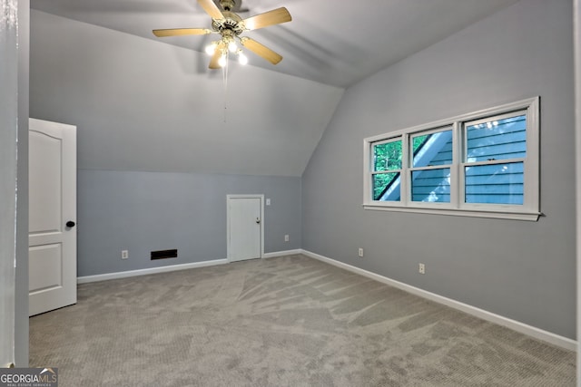 bonus room featuring lofted ceiling, carpet floors, baseboards, and a ceiling fan