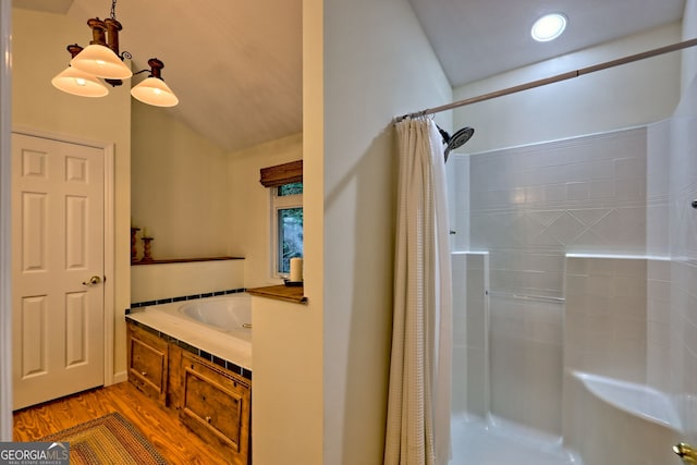 full bathroom featuring a stall shower and wood finished floors