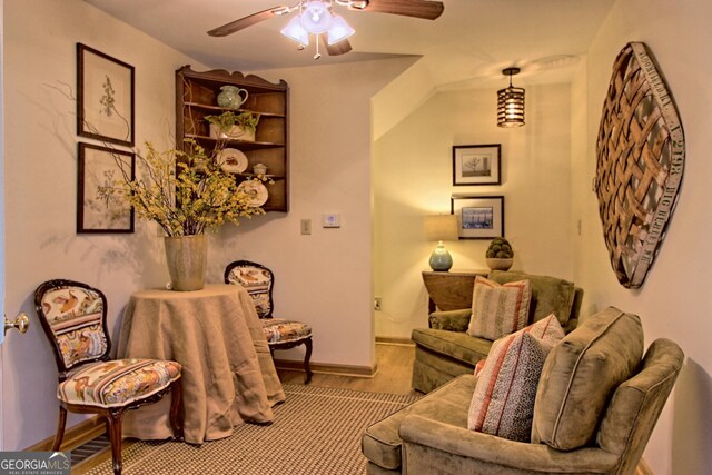 living room featuring ceiling fan and baseboards