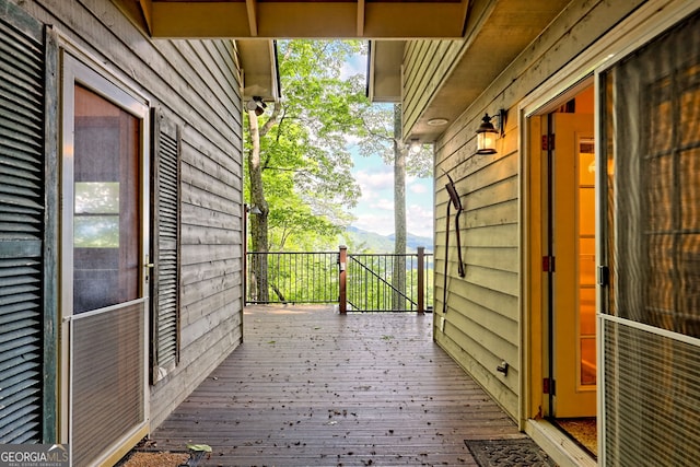wooden deck with a mountain view