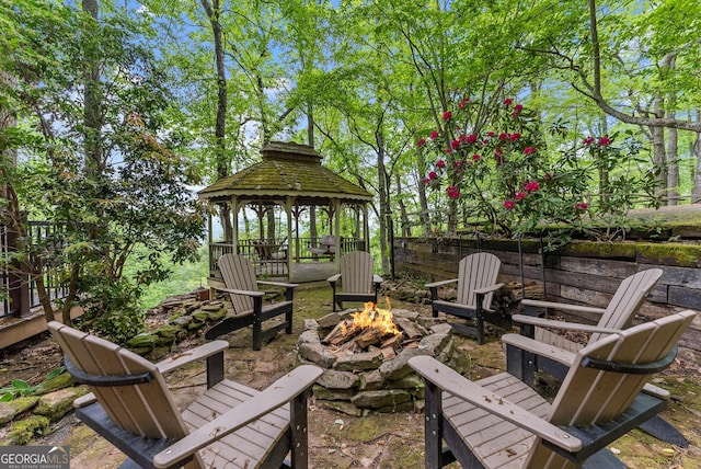 view of patio featuring an outdoor fire pit and a gazebo