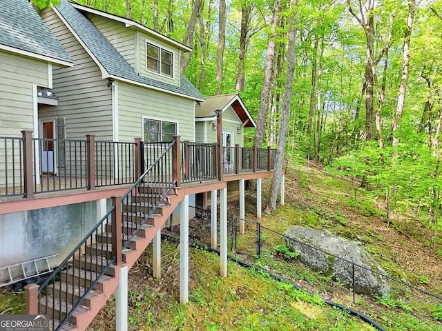 deck featuring stairway and fence