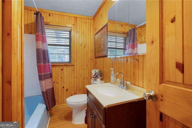 413 New Town Rd NE, Calhoun, GA 30701 - full bathroom featuring toilet, vanity, wooden walls, a textured ceiling, and wood finished floors