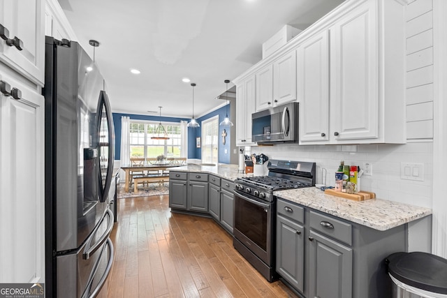 58 Gables Way, Newnan, GA 30265 - kitchen with stainless steel appliances, gray cabinetry, white cabinetry, hardwood / wood-style floors, and recessed lighting