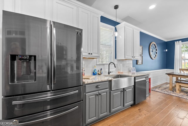 58 Gables Way, Newnan, GA 30265 - kitchen with appliances with stainless steel finishes, gray cabinets, a sink, light wood-type flooring, and a wainscoted wall