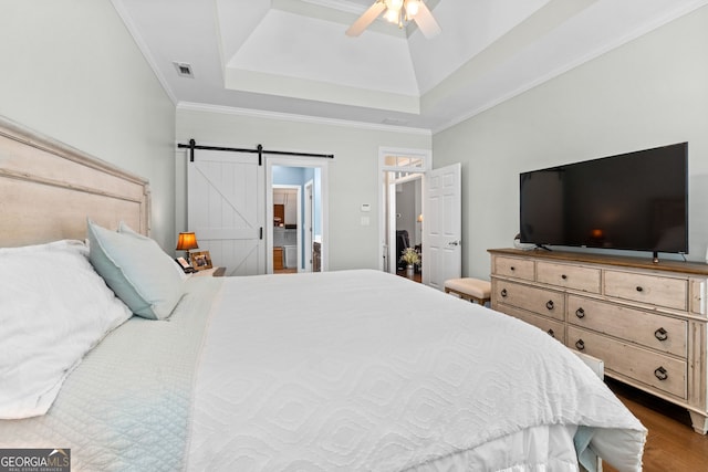 58 Gables Way, Newnan, GA 30265 - bedroom with wood finished floors, crown molding, a barn door, ceiling fan, and a raised ceiling