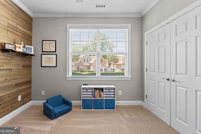 58 Gables Way, Newnan, GA 30265 - living area with healthy amount of natural light, ornamental molding, carpet, baseboards, and wooden walls