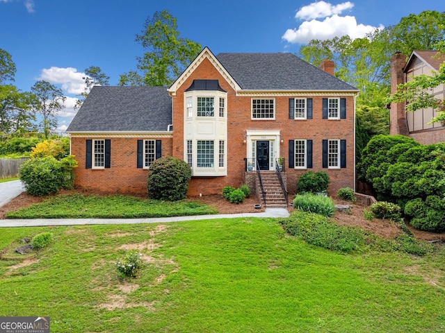 720 Belgrave Ln, Tucker, GA 30084 - colonial house with a chimney, a front lawn, brick siding, and roof with shingles