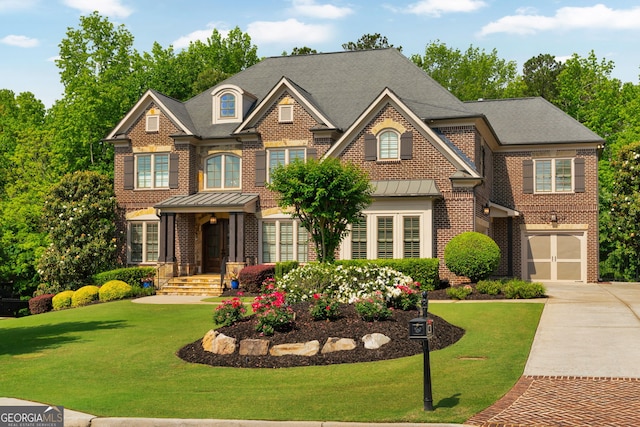 colonial-style house featuring brick siding, concrete driveway, a front yard, and a garage