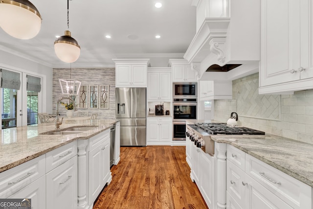 kitchen with a sink, appliances with stainless steel finishes, tasteful backsplash, white cabinets, and recessed lighting