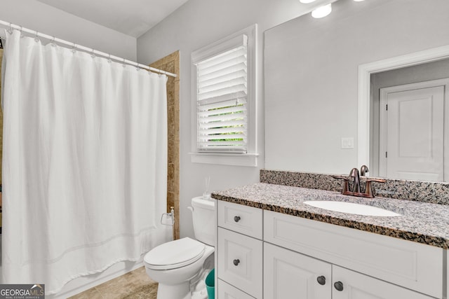 bathroom with toilet, vanity, and shower / tub combo