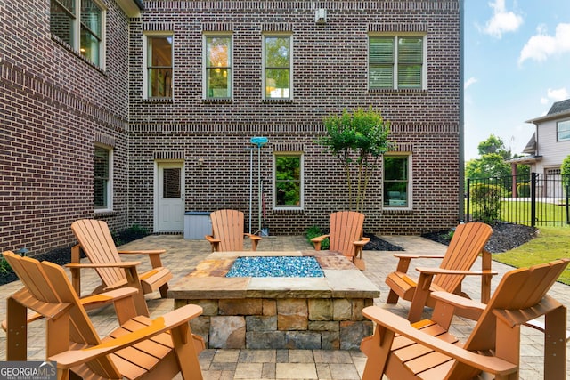 view of patio / terrace with an outdoor fire pit and fence