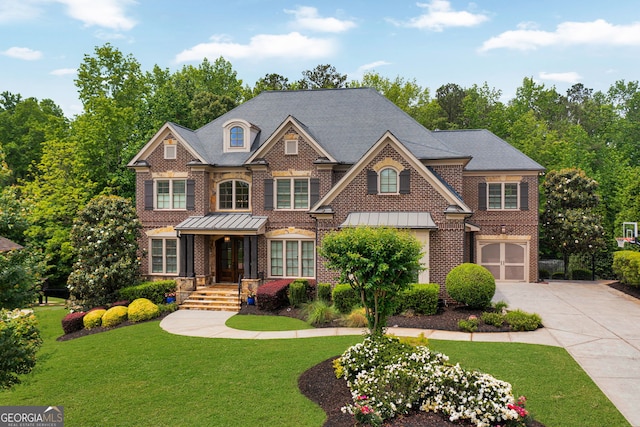 view of front facade featuring brick siding, concrete driveway, a front yard, and a standing seam roof