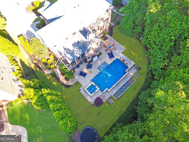 aerial view of property and surrounding area featuring a pool