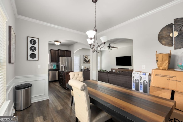 3406 Pennington Dr, Lithonia, GA 30038 - dining area with arched walkways, ornamental molding, dark wood-type flooring, wainscoting, and ceiling fan
