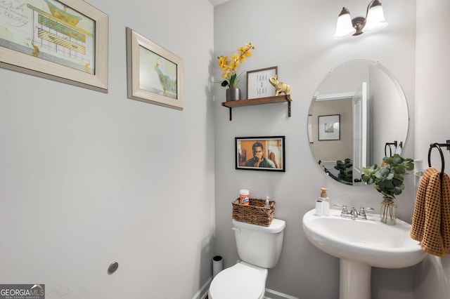3406 Pennington Dr, Lithonia, GA 30038 - bathroom with baseboards, toilet, and a sink