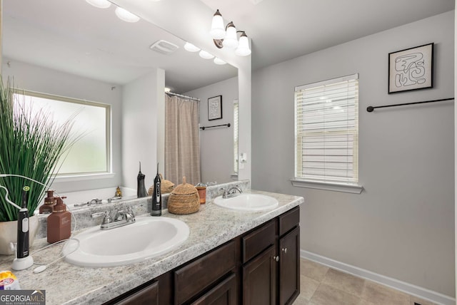 3406 Pennington Dr, Lithonia, GA 30038 - bathroom with double vanity and baseboards