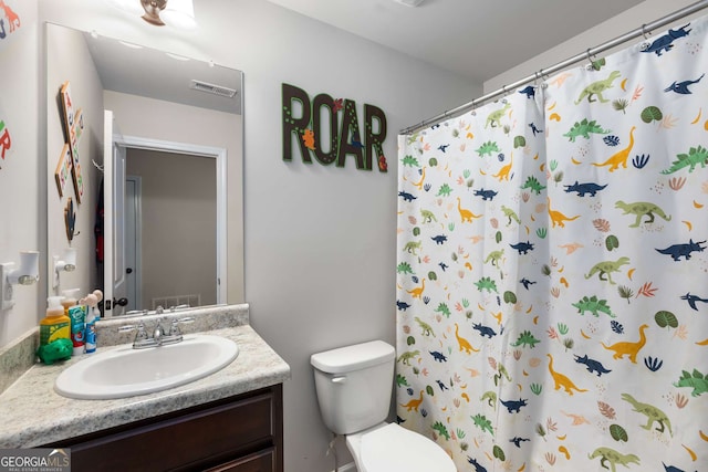 3406 Pennington Dr, Lithonia, GA 30038 - bathroom with vanity, toilet, and curtained shower