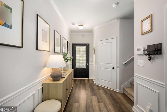 3406 Pennington Dr, Lithonia, GA 30038 - foyer entrance featuring dark wood-style flooring, crown molding, stairway, and wainscoting