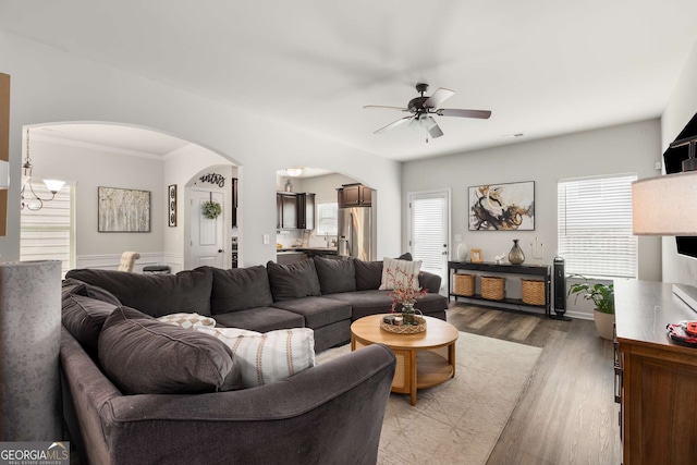3406 Pennington Dr, Lithonia, GA 30038 - living area featuring arched walkways, a ceiling fan, wood finished floors, and ornamental molding