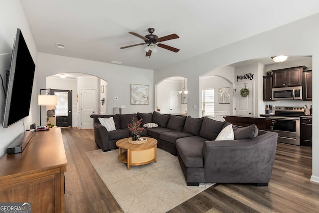 3406 Pennington Dr, Lithonia, GA 30038 - living room with arched walkways, ceiling fan, and wood finished floors