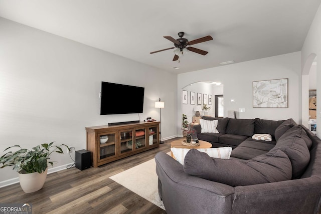 3406 Pennington Dr, Lithonia, GA 30038 - living area featuring arched walkways, a ceiling fan, wood finished floors, and baseboards