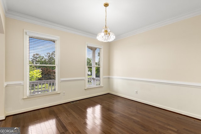 unfurnished room featuring a chandelier, dark wood finished floors, crown molding, and baseboards
