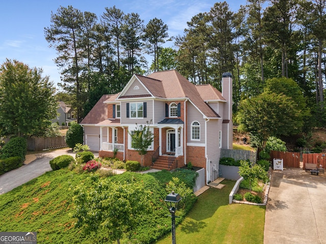 craftsman-style house with a chimney, driveway, brick siding, and a garage