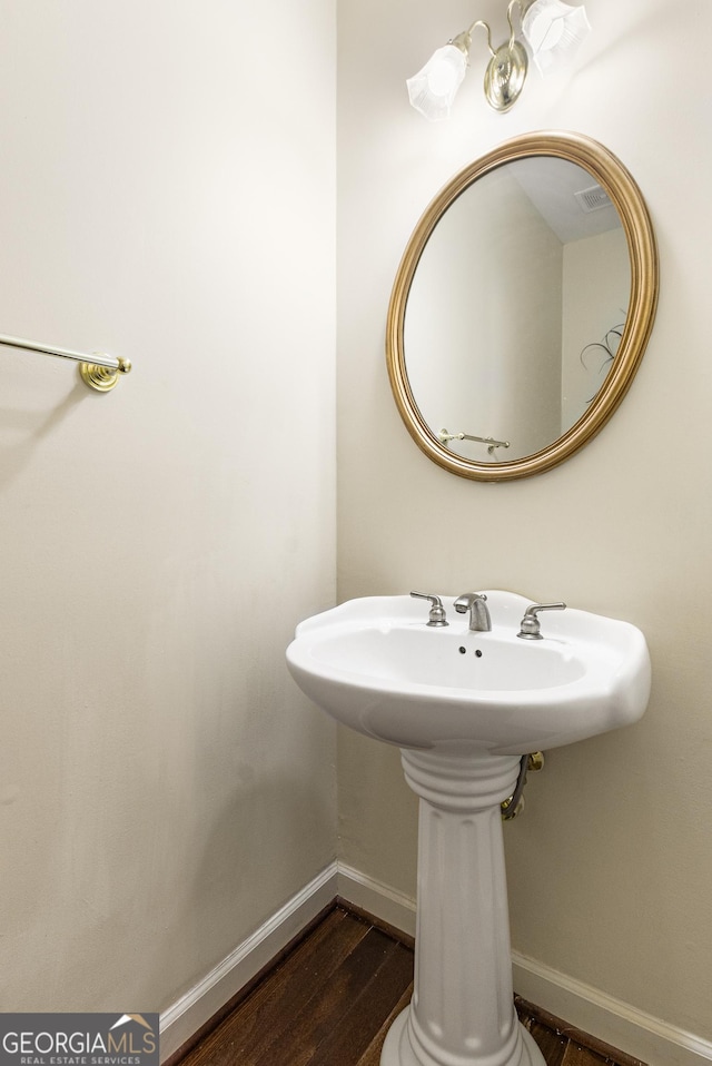 bathroom featuring baseboards and wood finished floors